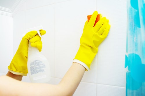 Staff member applying safe cleaning practices in an occupied building