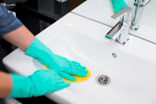 Professional home cleaning tasks in Enfield kitchen and bathroom
